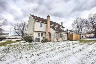 a house with a chimney in the snow at East Earl Retreat with Hot Tub Less Than 4 Mi to Town! in East Earl
