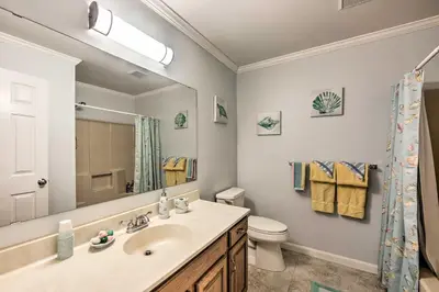 a bathroom with a sink and a toilet and a mirror at East Earl Retreat with Hot Tub Less Than 4 Mi to Town! in East Earl