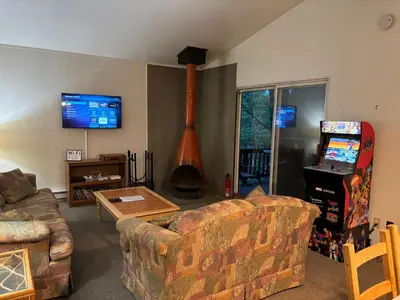 a living room with a couch and a video game at Clubhouse Lakeview Chalet in East Stroudsburg