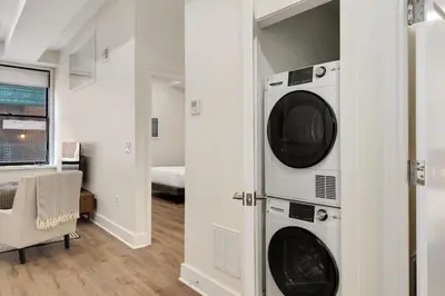 a laundry room with a washer and dryer at The Ledger Residences by Sosuite - Old City in Philadelphia