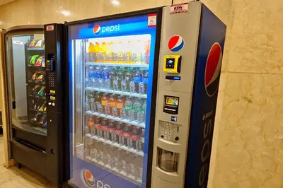 a vending machine filled with lots of bottles of soda at The Ledger Residences by Sosuite - Old City in Philadelphia