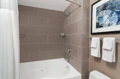 a bathroom with a white toilet and a sink at Fairfield Inn & Suites by Marriott New York Staten Island in Staten Island