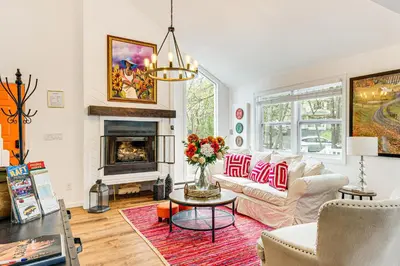 a living room with a couch and a fireplace at Deck, Fire Pit and Pool Access at Poconos Retreat! in East Stroudsburg