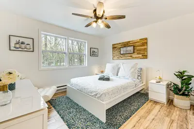 a bedroom with a bed and a ceiling fan at Deck, Fire Pit and Pool Access at Poconos Retreat! in East Stroudsburg
