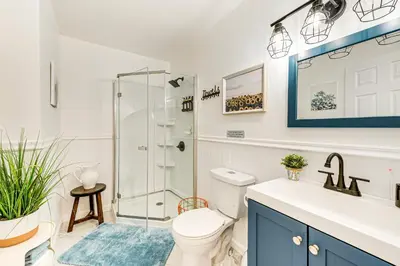 a bathroom with a shower and a toilet and a sink at Deck, Fire Pit and Pool Access at Poconos Retreat! in East Stroudsburg
