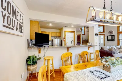 a kitchen and living room with a table and chairs at Northridge 393 in Tannersville