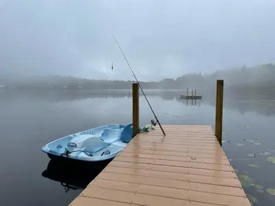 a boat tied to a dock on a lake at Lakeside Reflections in Oxford