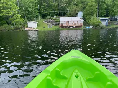 a green kayak in a body of water at Lakeside Reflections in Oxford