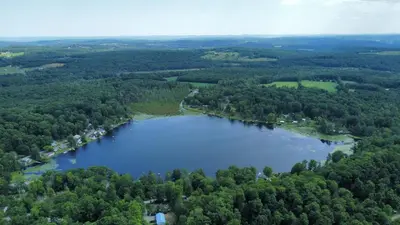 an aerial view of a lake in the woods at Lakeside Reflections in Oxford