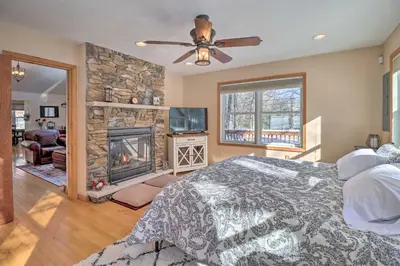 a bedroom with a bed and a fireplace at Deck, Pool, Trails Access Pocono Family Home! in Albrightsville