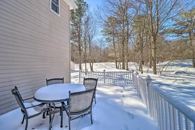 a table and chairs on a porch covered in snow at Deck, Pool, Trails Access Pocono Family Home! in Albrightsville