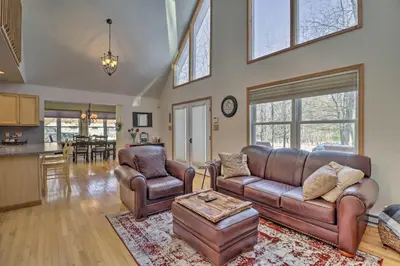 a living room with a leather couch and chairs at Deck, Pool, Trails Access Pocono Family Home! in Albrightsville