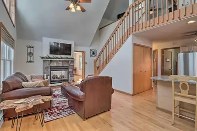 a living room with a couch and a fireplace at Deck, Pool, Trails Access Pocono Family Home! in Albrightsville