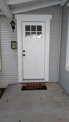 a white door with a welcome mat in front of it at Lewisburg duplex in Lewisburg