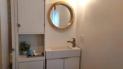 a bathroom with a sink and a mirror at Lewisburg duplex in Lewisburg