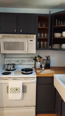 a kitchen with a white stove and a microwave at Lewisburg duplex in Lewisburg