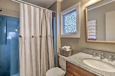 a bathroom with a toilet and a sink and a shower at Fire Pit and Grill Lakefront Poconos Cottage! in East Stroudsburg