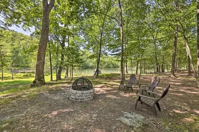two chairs and a fire pit in a park at Fire Pit and Grill Lakefront Poconos Cottage! in East Stroudsburg