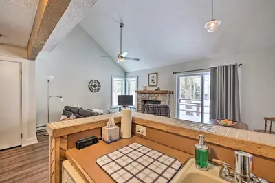a kitchen with a sink and a living room at Less Than 1 Mi to Jack Frost Lake Harmony Townhome! in Lake Harmony