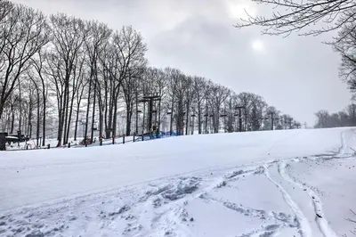 a snow covered field with trees and a ski lift at Less Than 1 Mi to Jack Frost Lake Harmony Townhome! in Lake Harmony