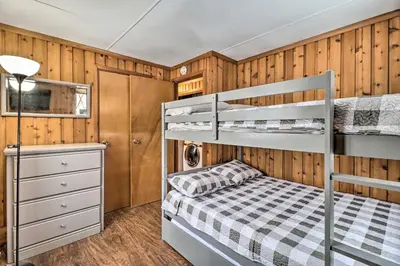 a bedroom with two bunk beds and a desk at Near Skiing Pocono Lake Cabin with Screened Patio in Pocono Lake
