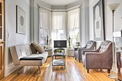 a living room with two chairs and a couch at Contemporary Jersey City Abode about 5 Mi to NYC! in Jersey City