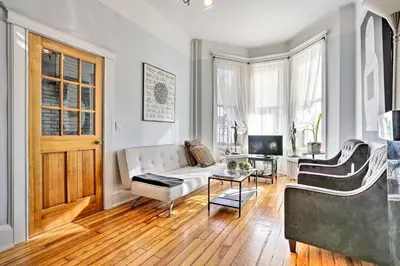 a living room with a couch and a table at Contemporary Jersey City Abode about 5 Mi to NYC! in Jersey City
