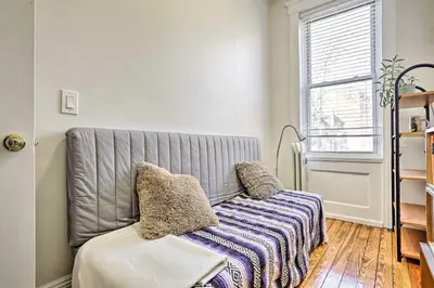 a living room with a couch and a window at Contemporary Jersey City Abode about 5 Mi to NYC! in Jersey City