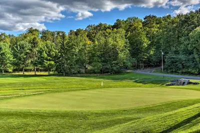 a view of a golf course with a green at Large Deck and Resort Amenities Lake Ariel Retreat in Lake Ariel