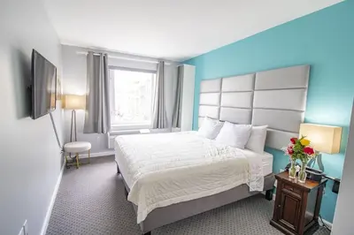a hotel room with a bed and a window at Canal Loft Hotel in New York