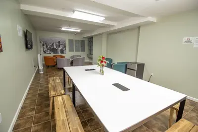 a conference room with a white table and chairs at Canal Loft Hotel in New York