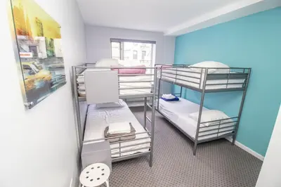 a room with three bunk beds in a room at Canal Loft Hotel in New York