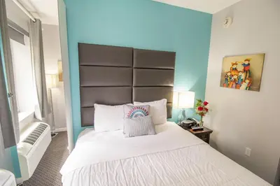 a bedroom with a large bed with a large headboard at Canal Loft Hotel in New York