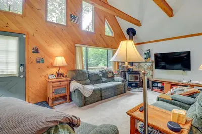 a living room with a couch and a tv at Lake Access and Decks Pet-Friendly Poconos Cabin! in Pocono Lake