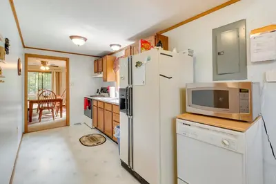 a kitchen with a refrigerator and a microwave at Lake Access and Decks Pet-Friendly Poconos Cabin! in Pocono Lake
