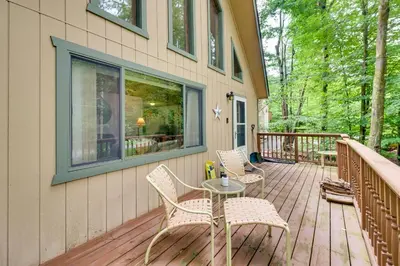 a patio with two chairs and a table on a deck at Lake Access and Decks Pet-Friendly Poconos Cabin! in Pocono Lake