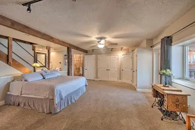 a bedroom with a bed and a table and a window at Dock and Hot Tub Susquehanna River Retreat! in Pequea
