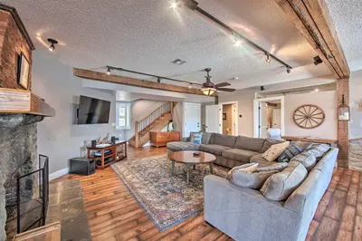 a living room with a couch and a fireplace at Dock and Hot Tub Susquehanna River Retreat! in Pequea