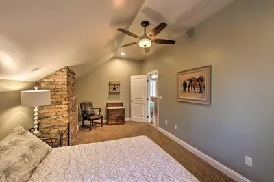 a bedroom with a bed and a ceiling fan at Dock and Hot Tub Susquehanna River Retreat! in Pequea