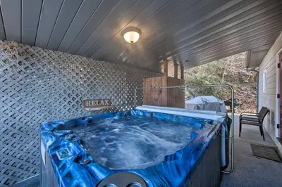 a large blue bath tub in a room at Dock and Hot Tub Susquehanna River Retreat! in Pequea