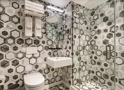 a bathroom with a toilet and a sink at The FIDI Hotel in New York