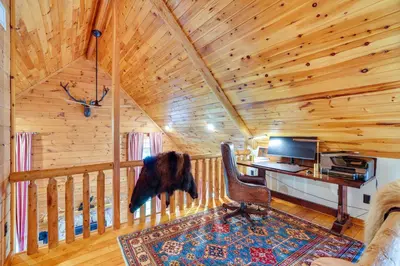 a log cabin office with a desk and a chair at Luxury Log Cabin with EV Charger and Mtn Views! in Blairstown
