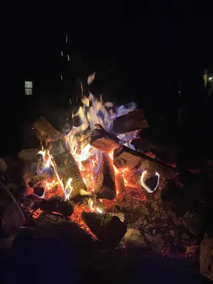 a fire pit in the dark with flames at Rv adventure Roscoe Pet friendly in Roscoe