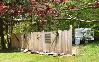 a wooden fence in a yard next to a truck at Rv adventure Roscoe Pet friendly in Roscoe