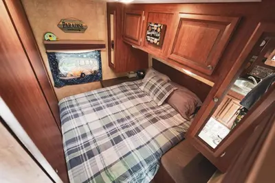 a small bed in the middle of a small room at Rv adventure Roscoe Pet friendly in Roscoe