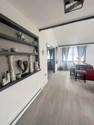 a living room with white walls and wooden floors at Amazing Poconos House . Sauna/Hot Tub/Private Pool in East Stroudsburg
