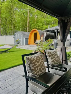 a patio with two chairs and a tent at Amazing Poconos House . Sauna/Hot Tub/Private Pool in East Stroudsburg