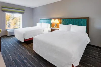 a hotel room with two beds and a window at Hampton Inn Monticello, Ny in Monticello