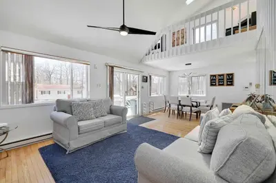 a living room with two couches and a dining room at Cozy Poconos Mountain House with 3 bedrooms in Tobyhanna