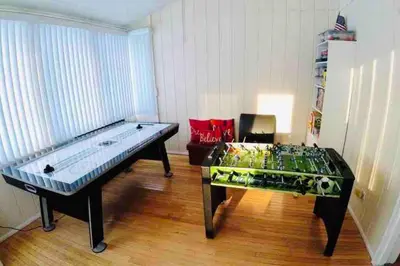 a room with a glass pool table and a chair at Cozy Poconos Mountain House with 3 bedrooms in Tobyhanna
